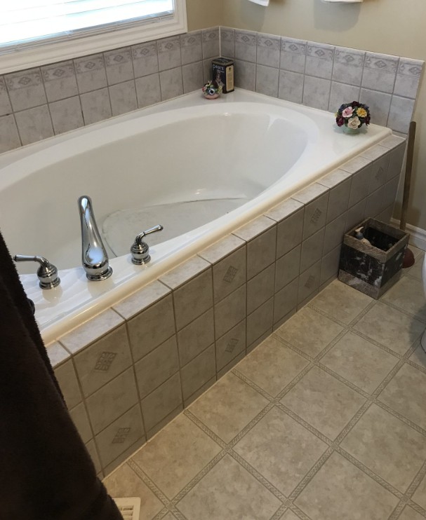 Before: an outdated tiled garden tub